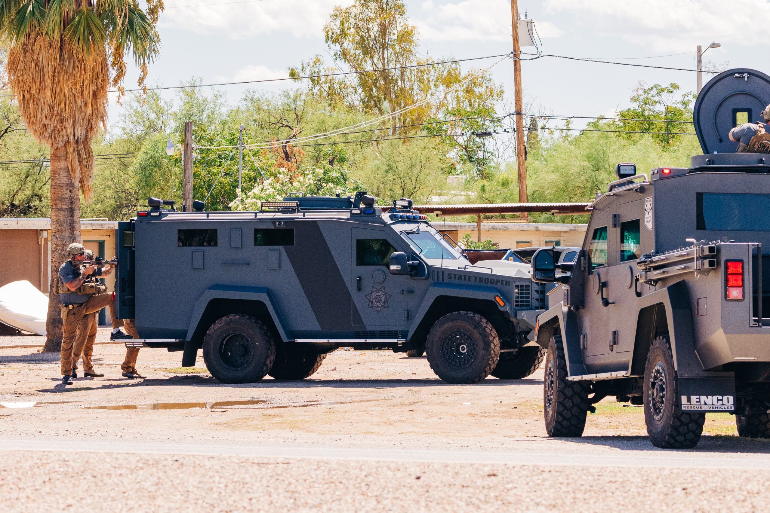 A special tactics team using heavy armored vehicles serves a search warrant